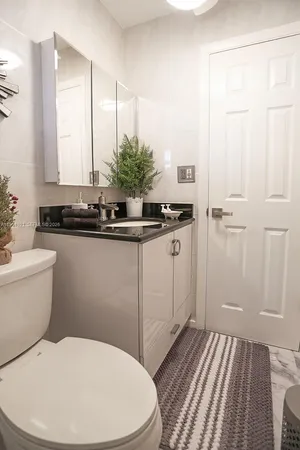 a bathroom with a sink a toilet and a shower