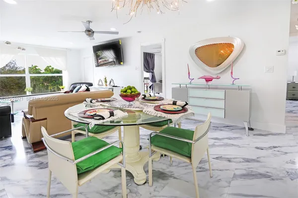 a view of a dining room with furniture and a floor to ceiling window