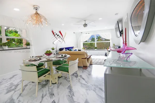 a dining room with furniture a rug and a chandelier