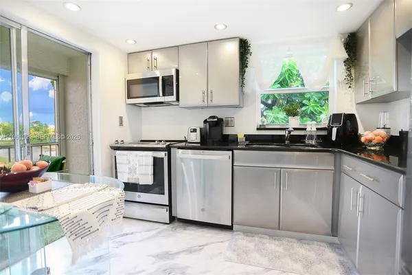 a kitchen with a sink stove and microwave
