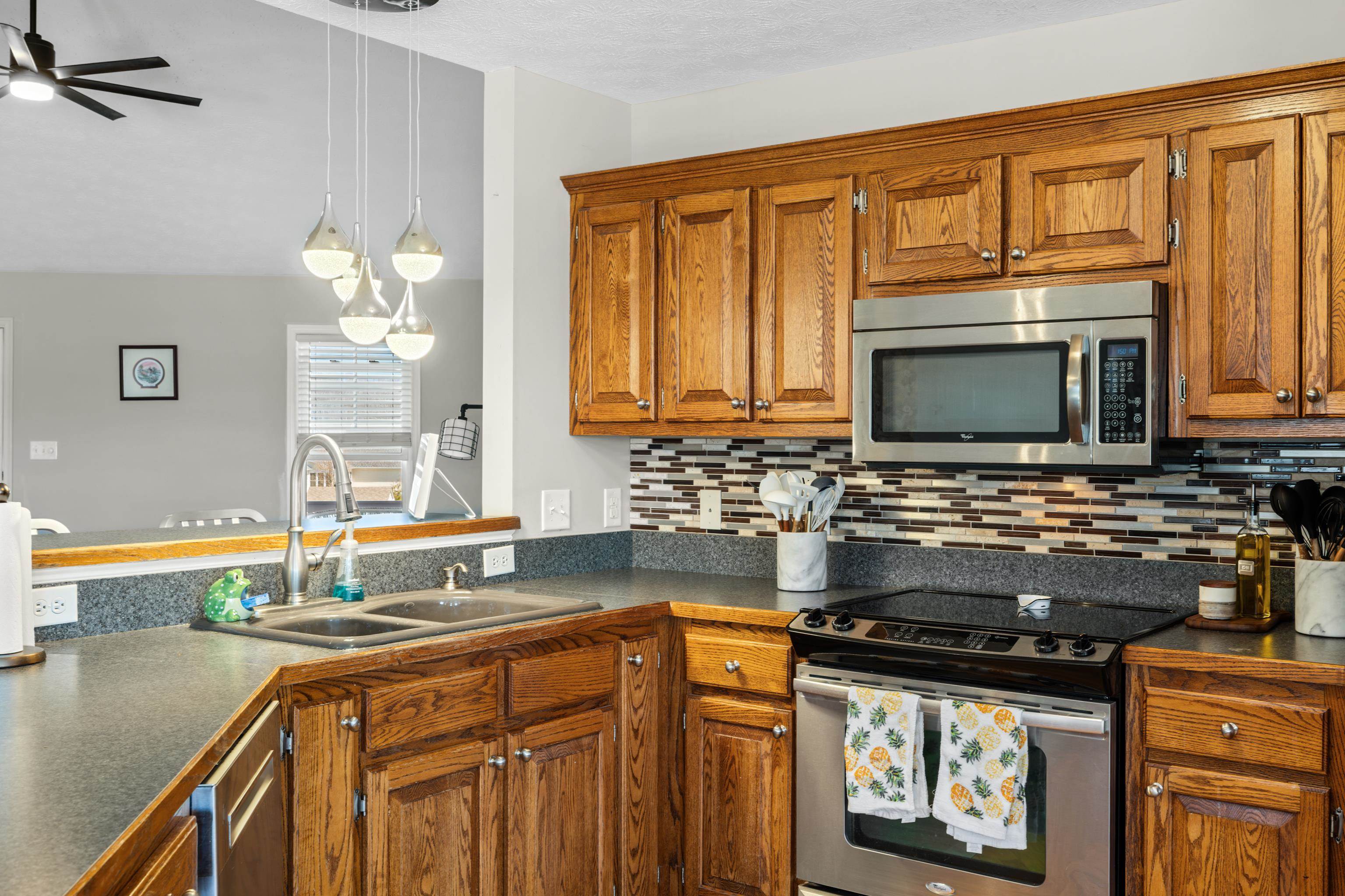 105 Stone Drive Stuarts Draft, VA 24477 - Photo 15 of 62 a kitchen with stainless steel appliances granite countertop a stove a sink and a microwave