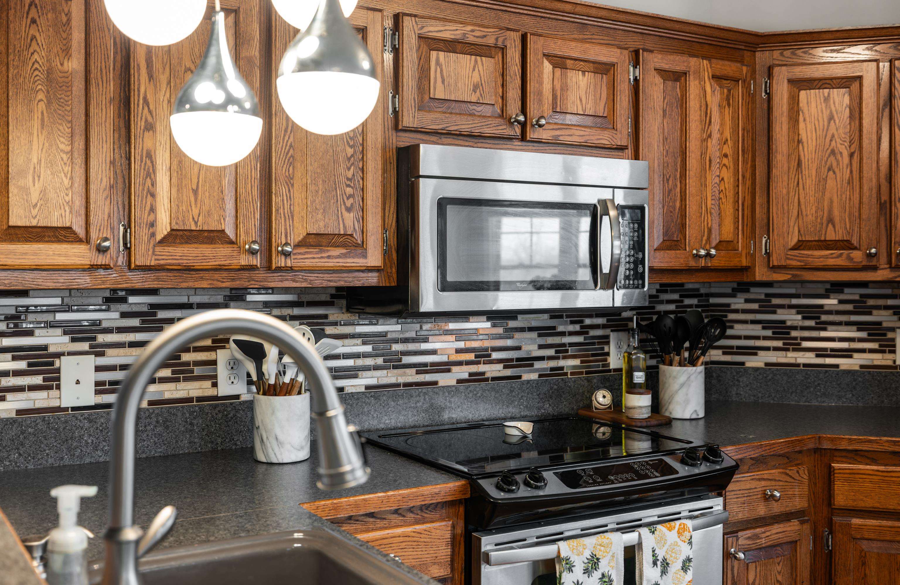 105 Stone Drive Stuarts Draft, VA 24477 - Photo 17 of 62 a kitchen with a stove a sink and a microwave