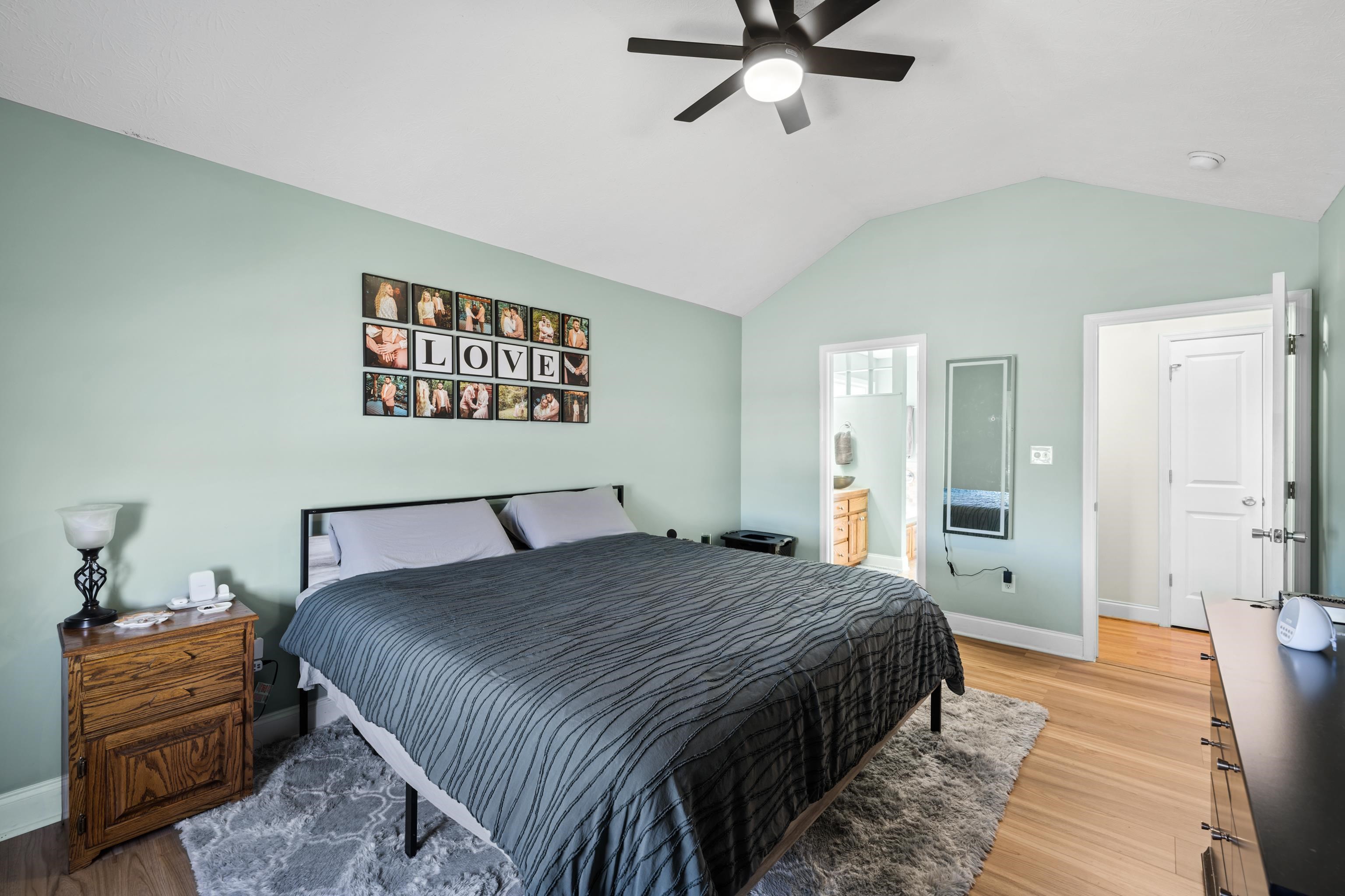 105 Stone Drive Stuarts Draft, VA 24477 - Photo 29 of 62 a bedroom with a bed and a chandelier