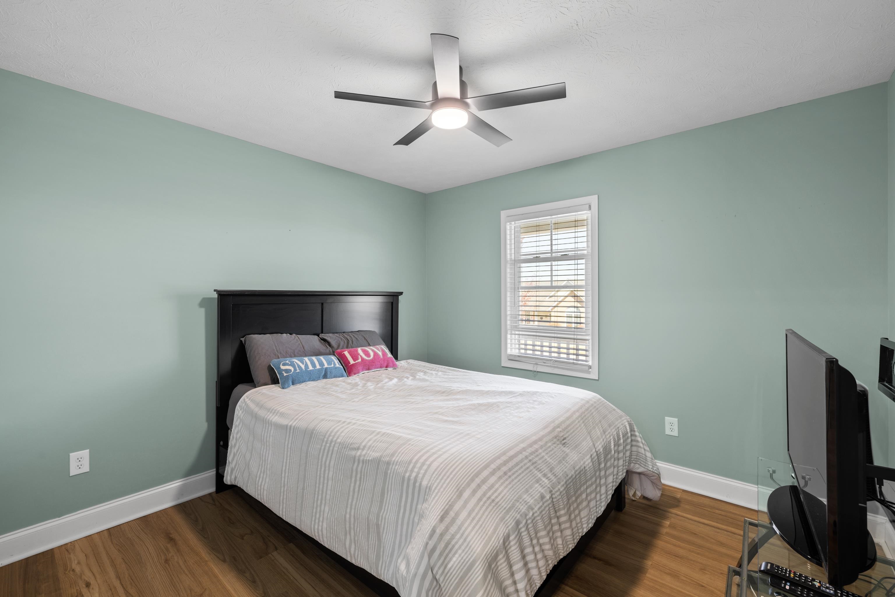 105 Stone Drive Stuarts Draft, VA 24477 - Photo 37 of 62 a bedroom with a bed and a flat tv screen on a dresser