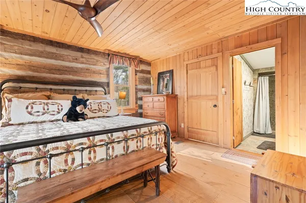 a bedroom with a bed a window and walk in closet