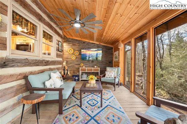 a living room with fireplace furniture and a floor to ceiling window