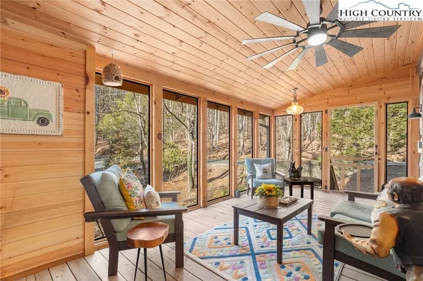 a living room with furniture and a floor to ceiling window