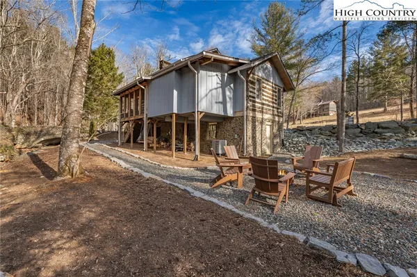 a view of a house with a yard and sitting area
