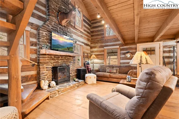 a living room with furniture a fireplace and a table