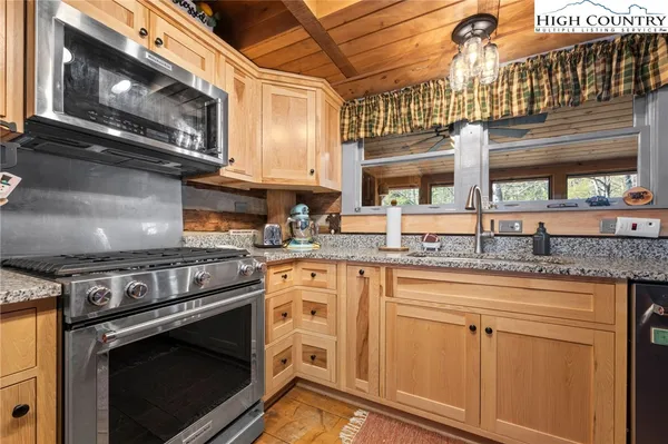 a kitchen with stainless steel appliances granite countertop a stove and a microwave