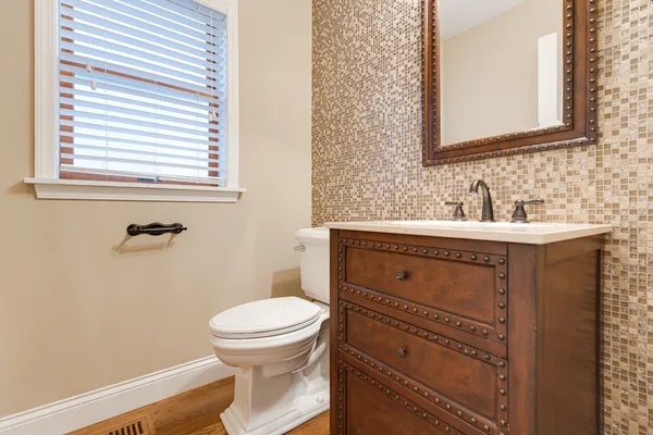 a bathroom with a sink a toilet and a mirror