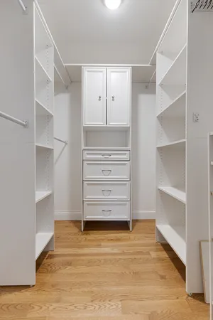 a view of walk in closet with empty racks
