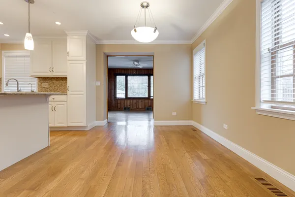 a view of a room with wooden floor and a window