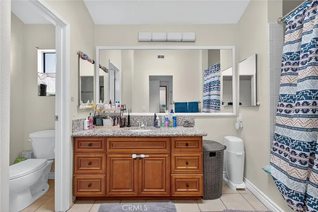 a spacious bathroom with a granite countertop sink and a mirror