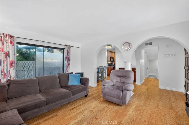 a living room with a couches and a large window with outer view