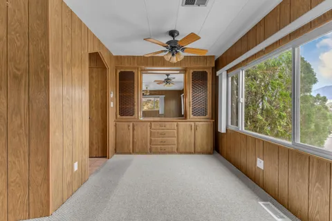a view of a house with a hallway and wooden floor