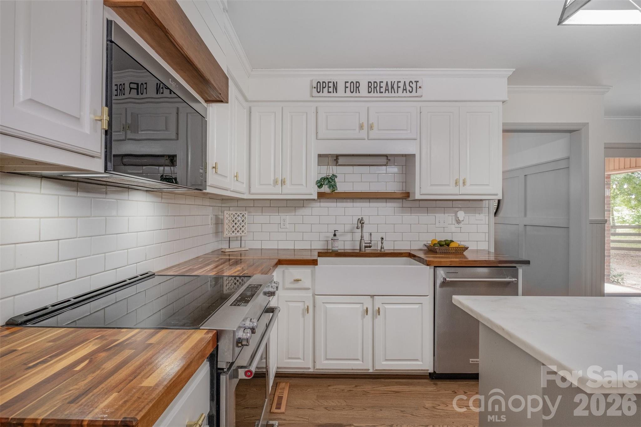 a kitchen with a sink a stove and cabinets