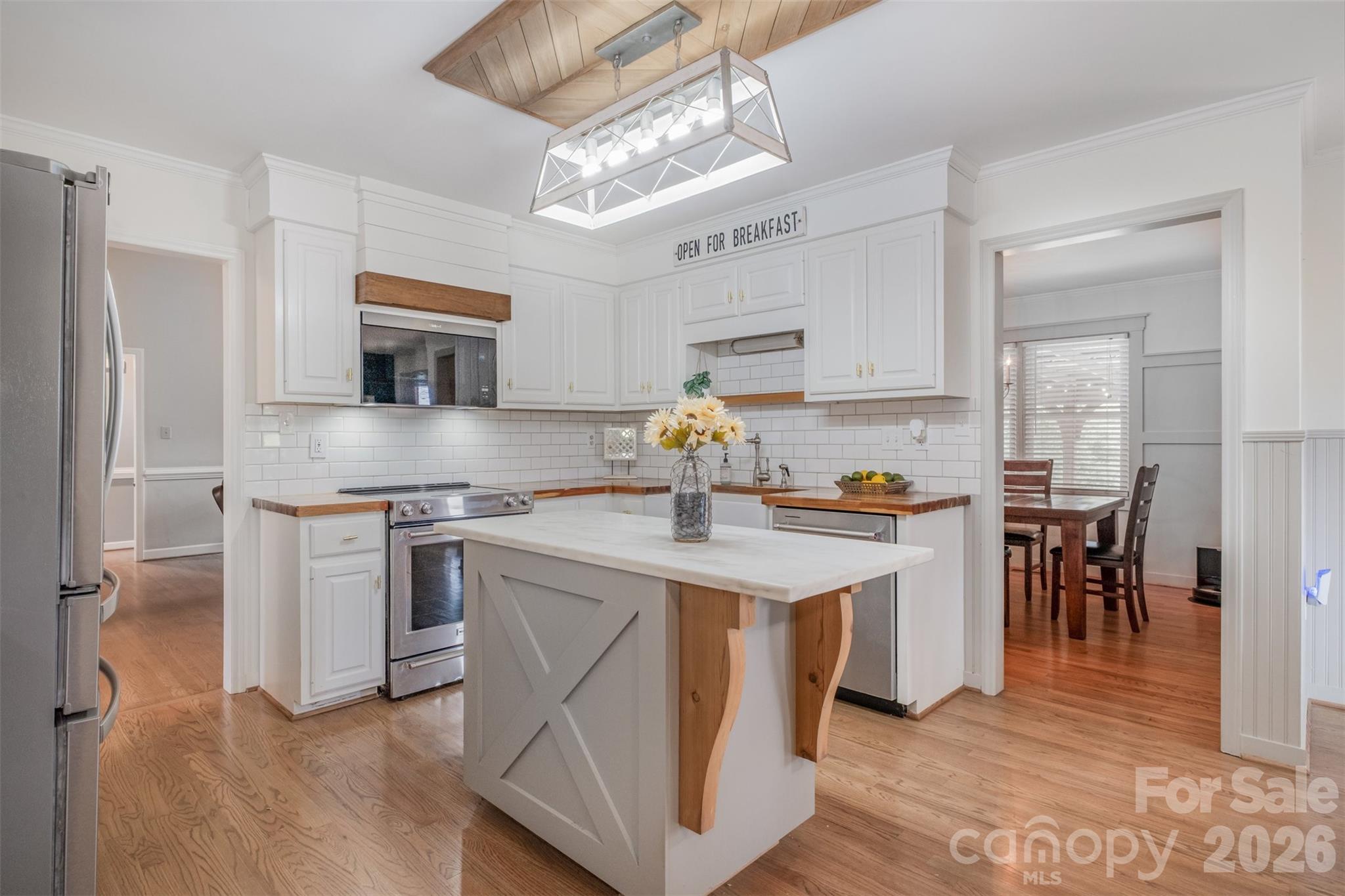 2212 Biggers Cemetery Road Monroe, NC 28110 - Photo 23 of 30 a kitchen with kitchen island granite countertop a sink cabinets and stainless steel appliances