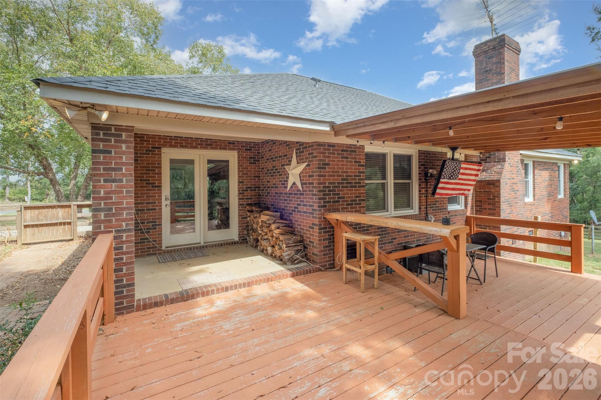2212 Biggers Cemetery Road Monroe, NC 28110 - Photo 28 of 30 a view of a patio with table and chairs with wooden floor and fence