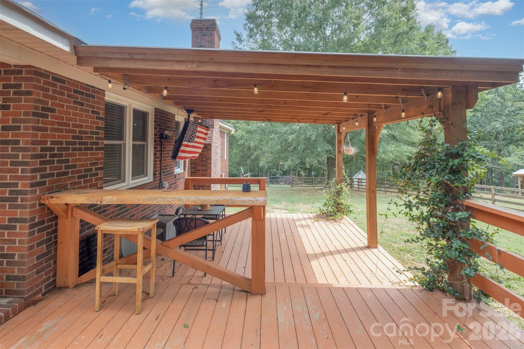 2212 Biggers Cemetery Road Monroe, NC 28110 - Photo 29 of 30 a roof deck with table and chairs a barbeque with wooden floor