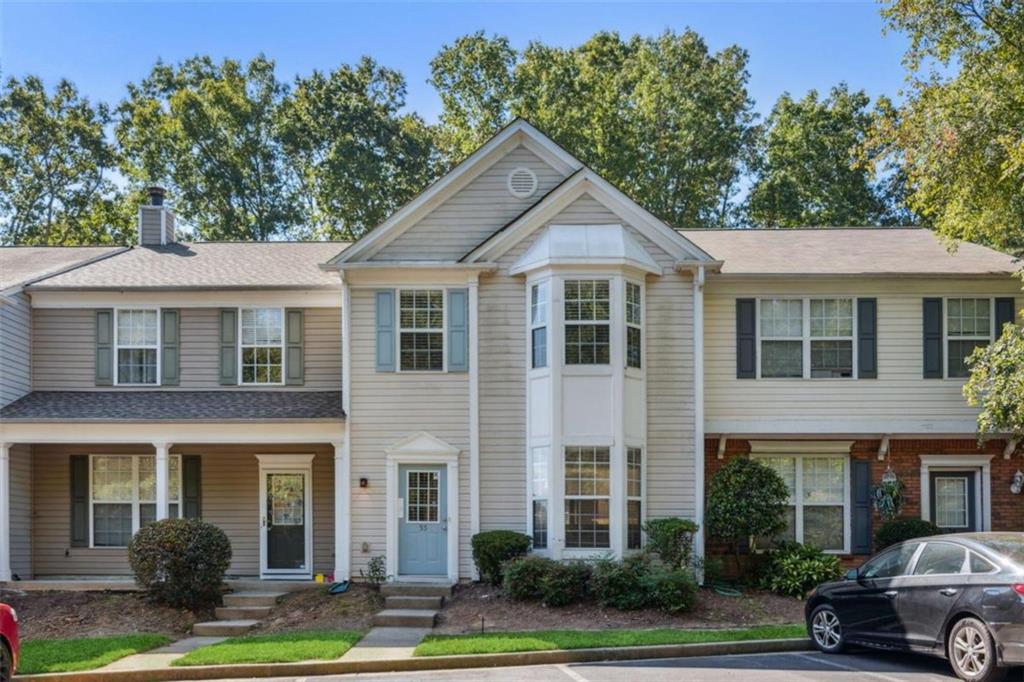 9155 Nesbit Ferry Road, Unit 55 Alpharetta, GA 30022 - Photo 1 of 1 a front view of a house with a yard