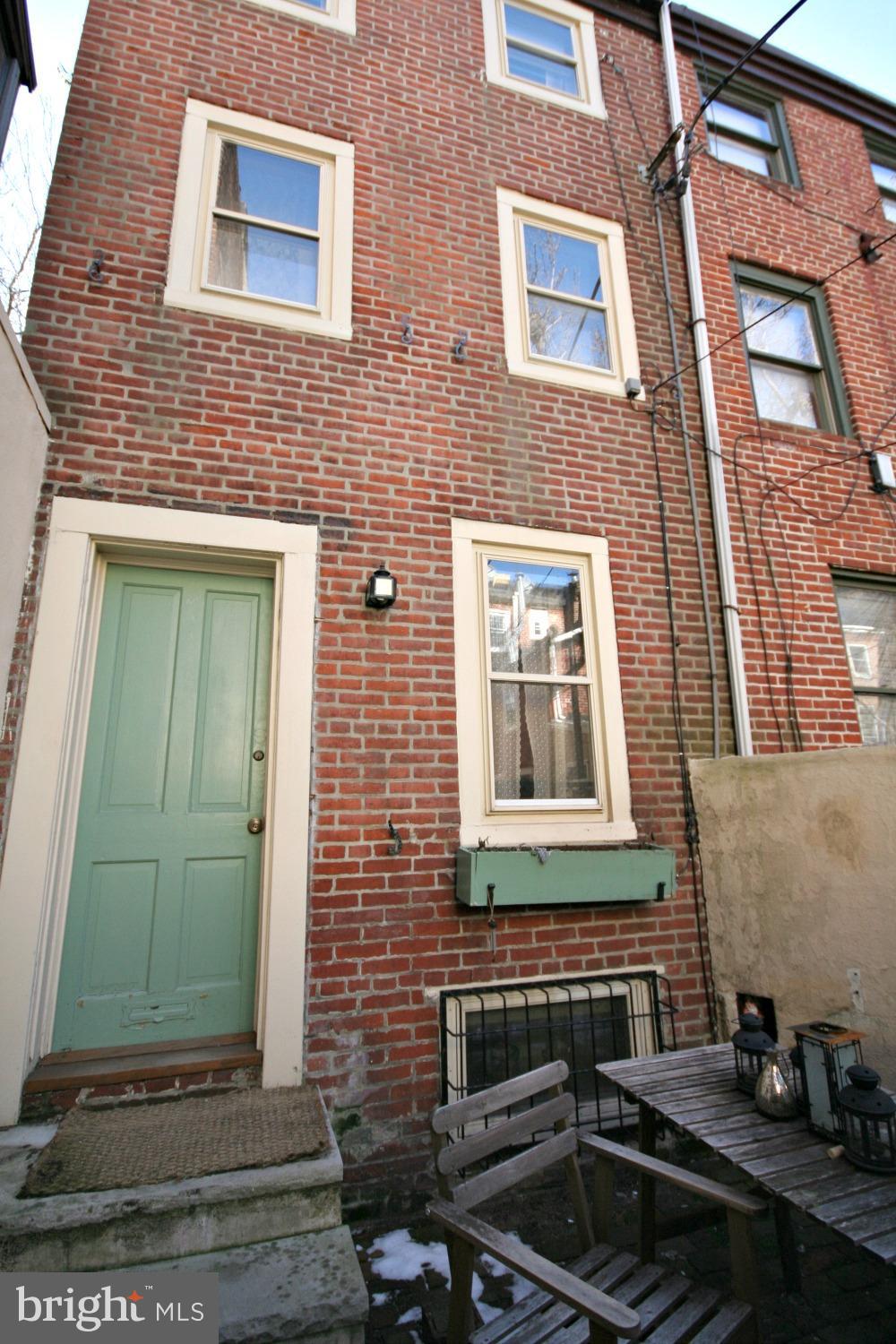 214 Monroe Street Philadelphia, PA 19147 - Photo 11 of 11 a brick building with a door and a window