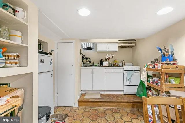 a kitchen with stainless steel appliances cabinets and a window