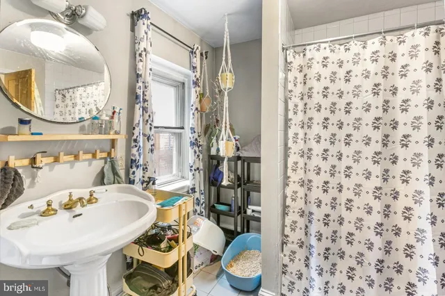 a bathroom with a sink toilet and mirror
