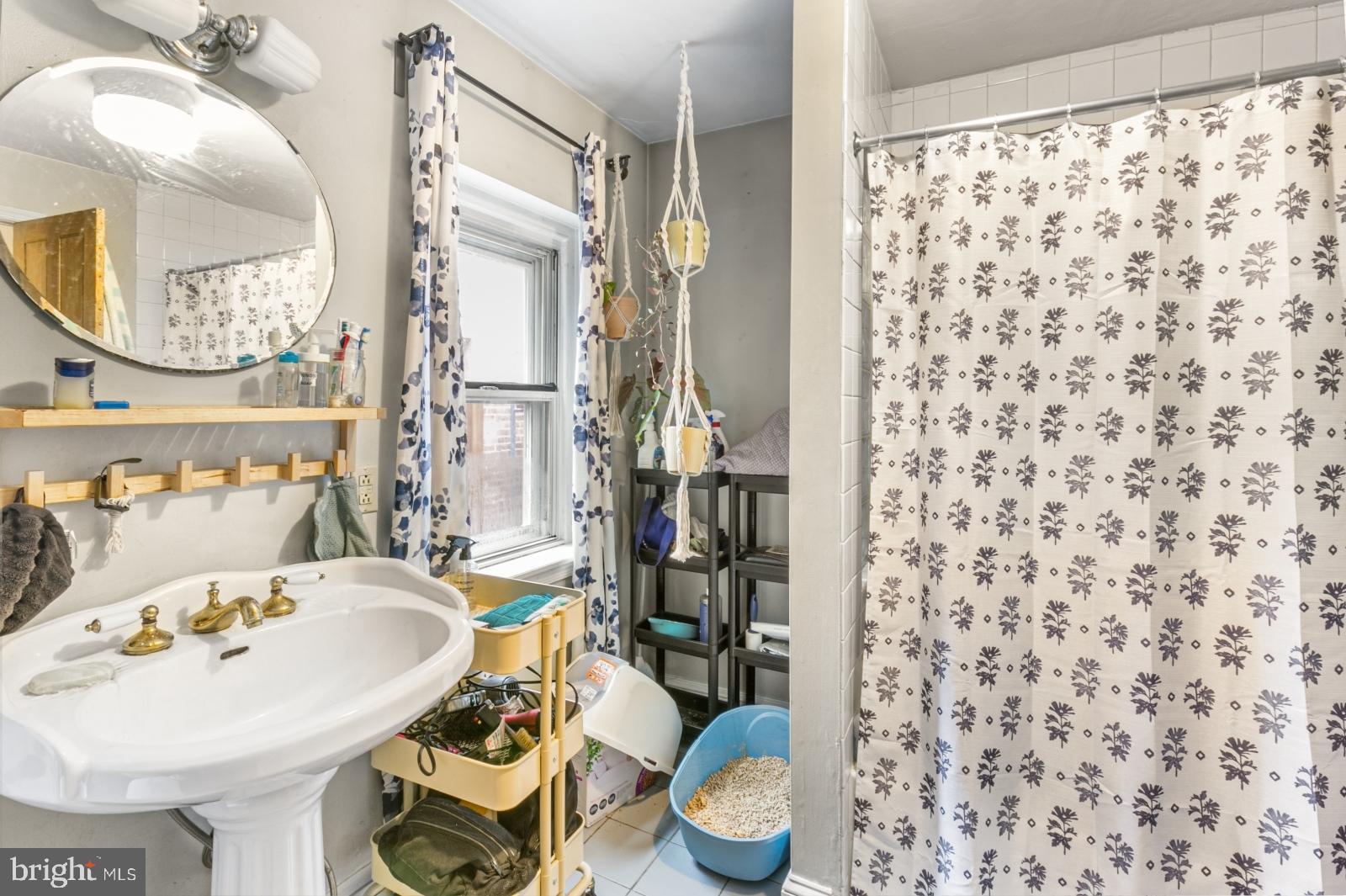 214 Monroe Street Philadelphia, PA 19147 - Photo 6 of 11 a bathroom with a sink toilet and mirror