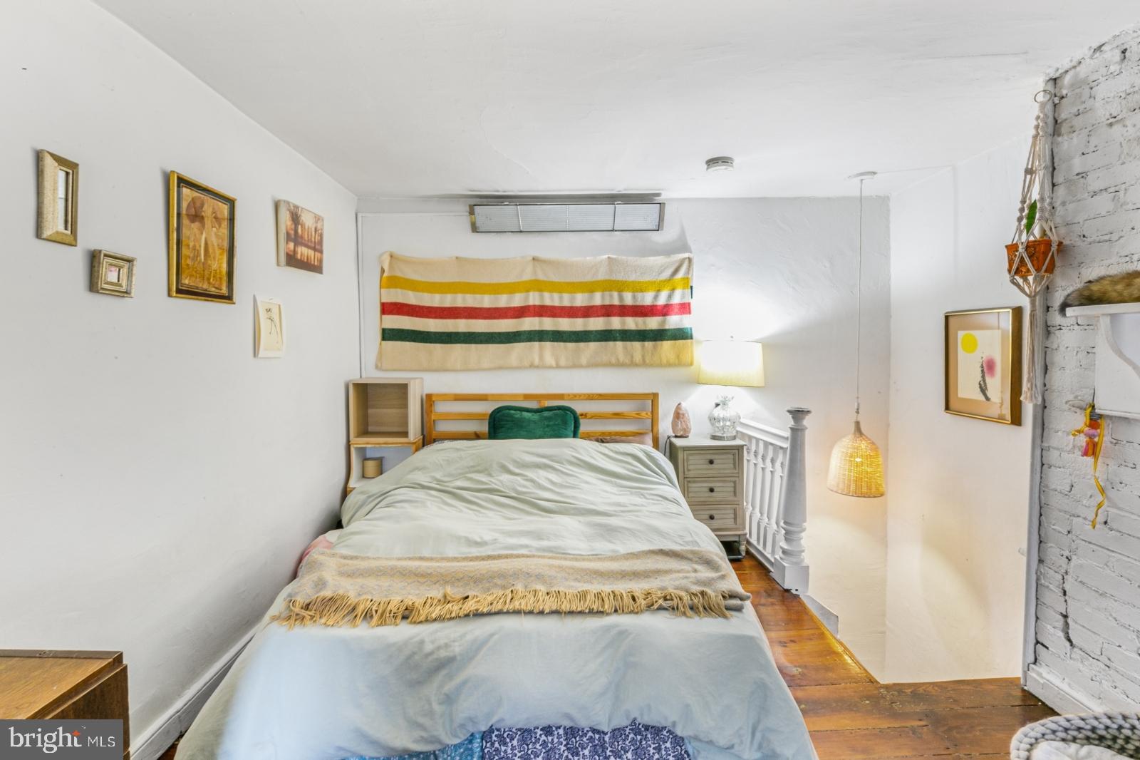 214 Monroe Street Philadelphia, PA 19147 - Photo 7 of 11 a bed sitting in a bedroom next to a window