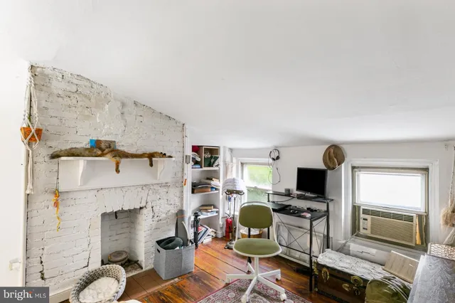 a living room with furniture a fireplace and flat screen tv