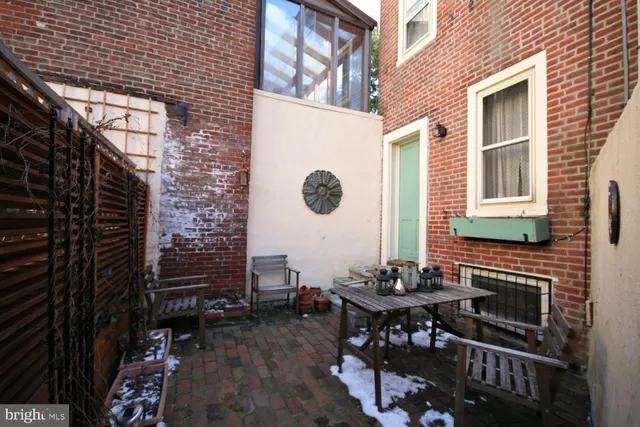a view of a patio with table and chairs and potted plants