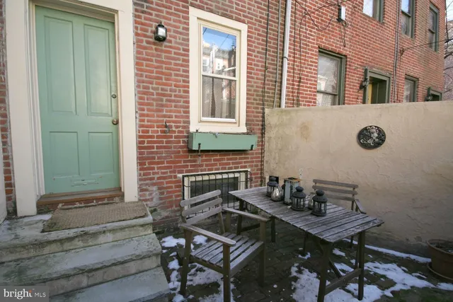 a backyard of a house with table and chairs