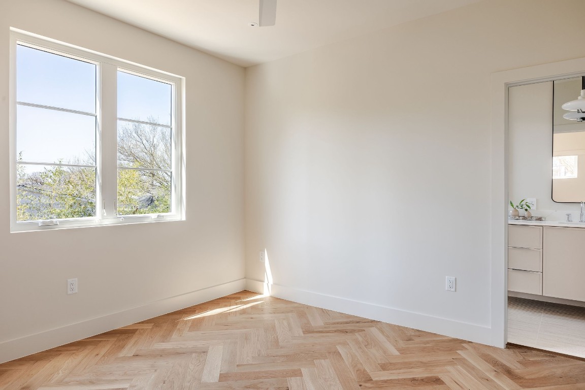 1802 Overhill Drive, Unit A Austin, TX 78721 - Photo 33 of 37 Primary bedroom features herringbone flooring like main floor.
