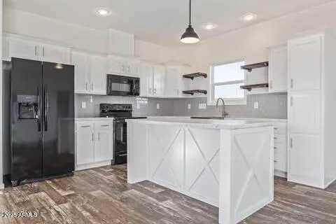 a kitchen with stainless steel appliances granite countertop a refrigerator a sink a stove a microwave and island