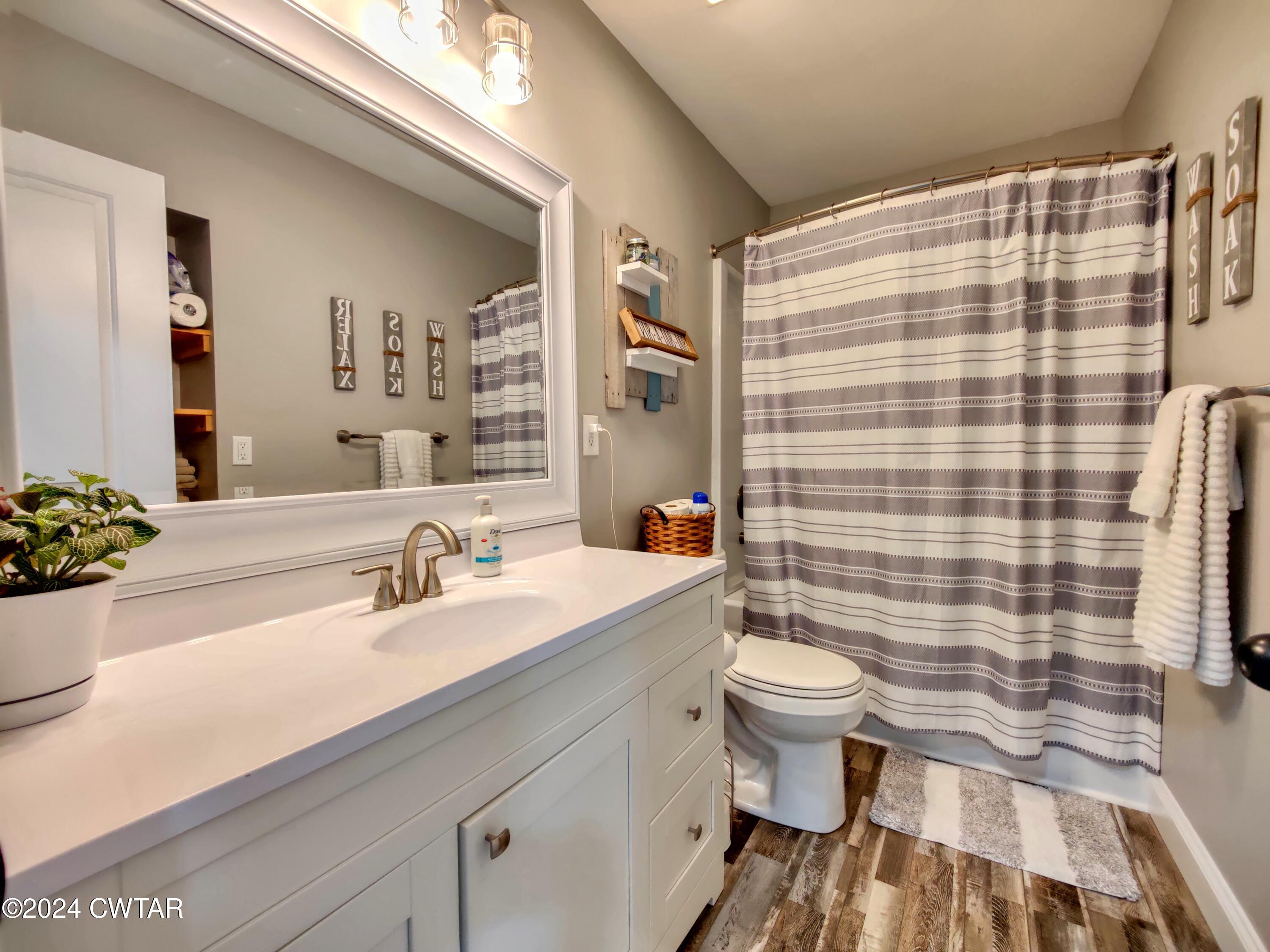 2694 East Grove Road Gleason, TN 38229 - Photo 11 of 30 a bathroom with a sink a toilet and shower
