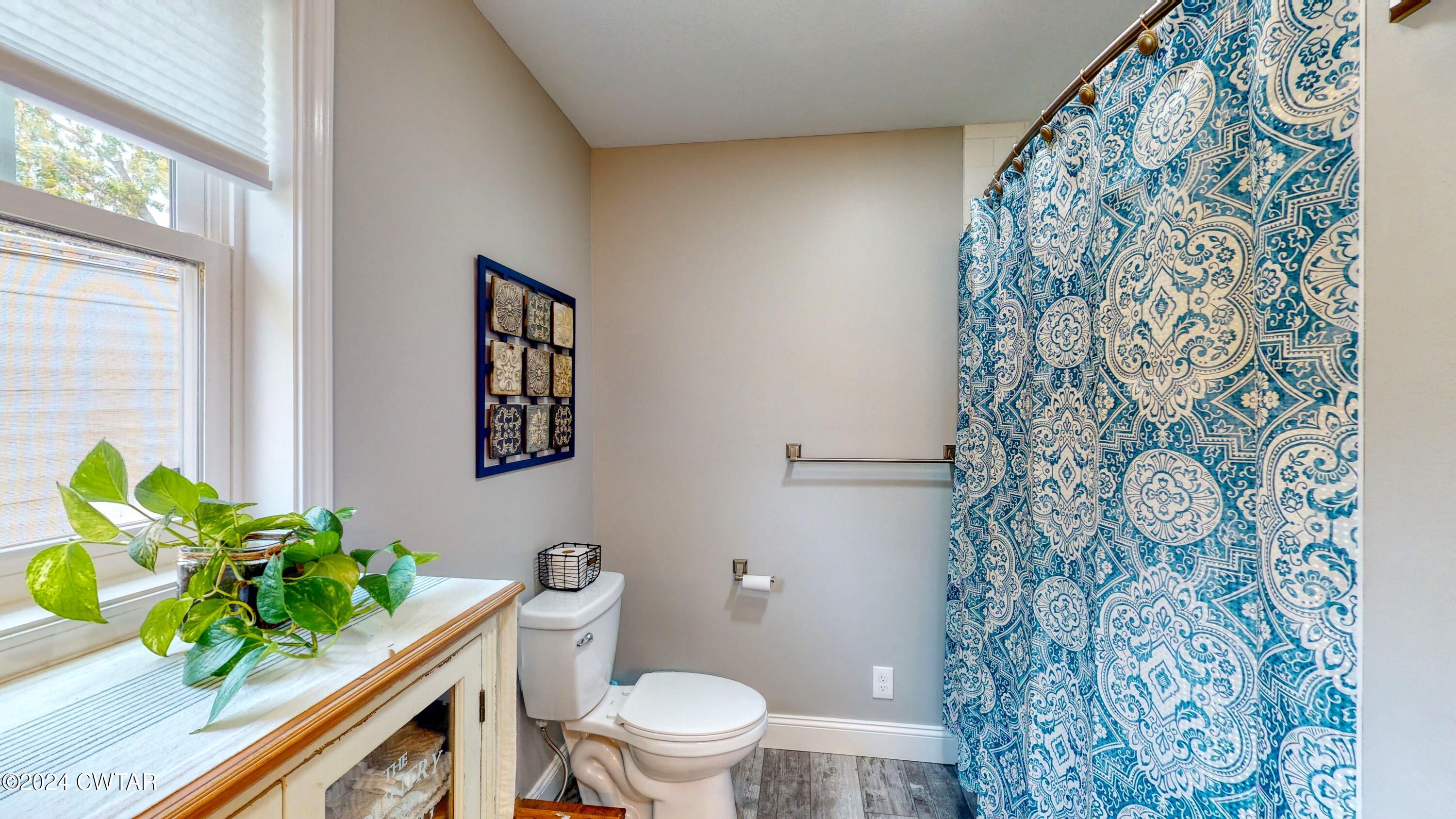 2694 East Grove Road Gleason, TN 38229 - Photo 15 of 30 a white toilet sitting next to a shower curtain