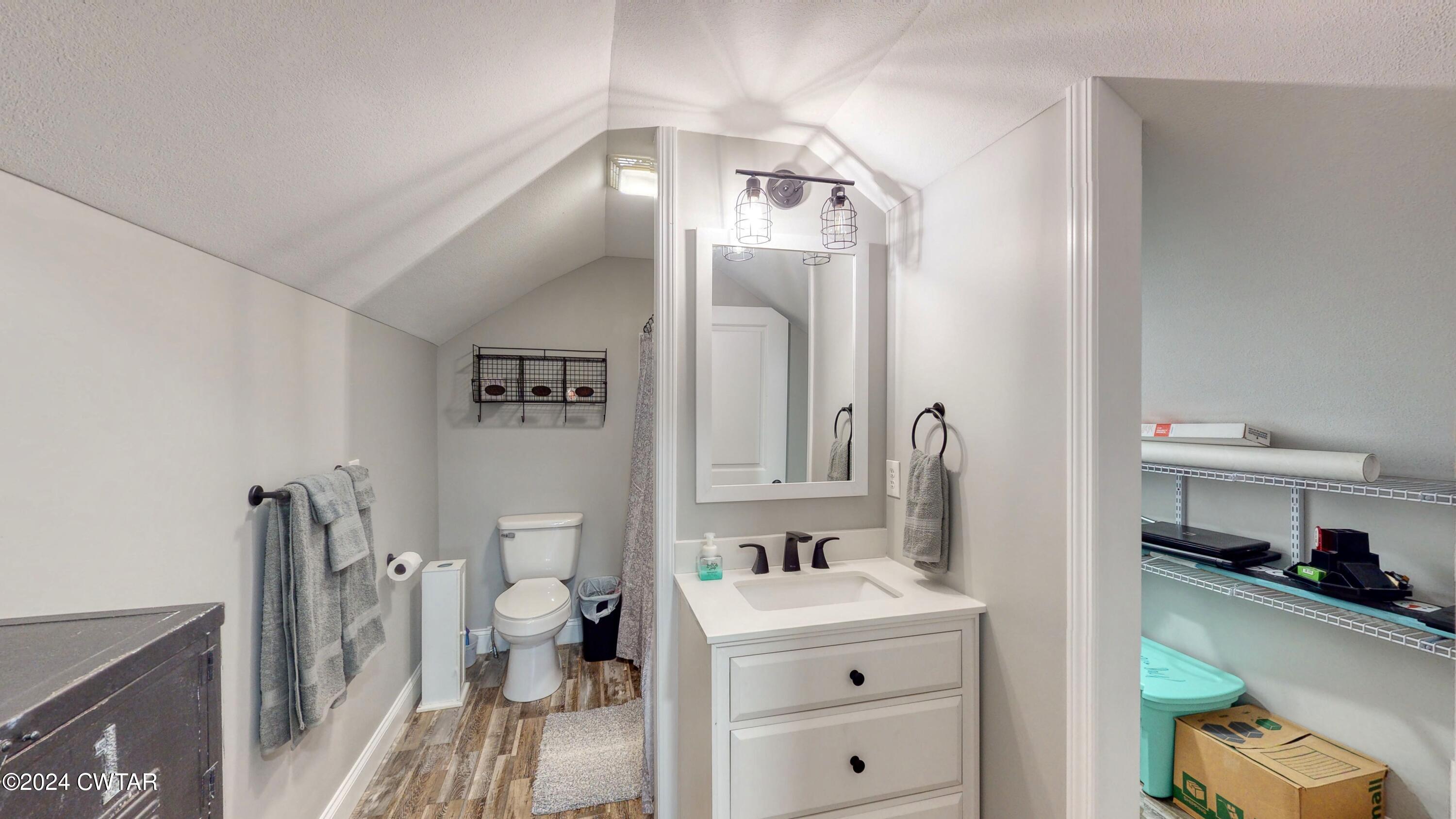 2694 East Grove Road Gleason, TN 38229 - Photo 17 of 30 a bathroom with a sink a toilet and a mirror
