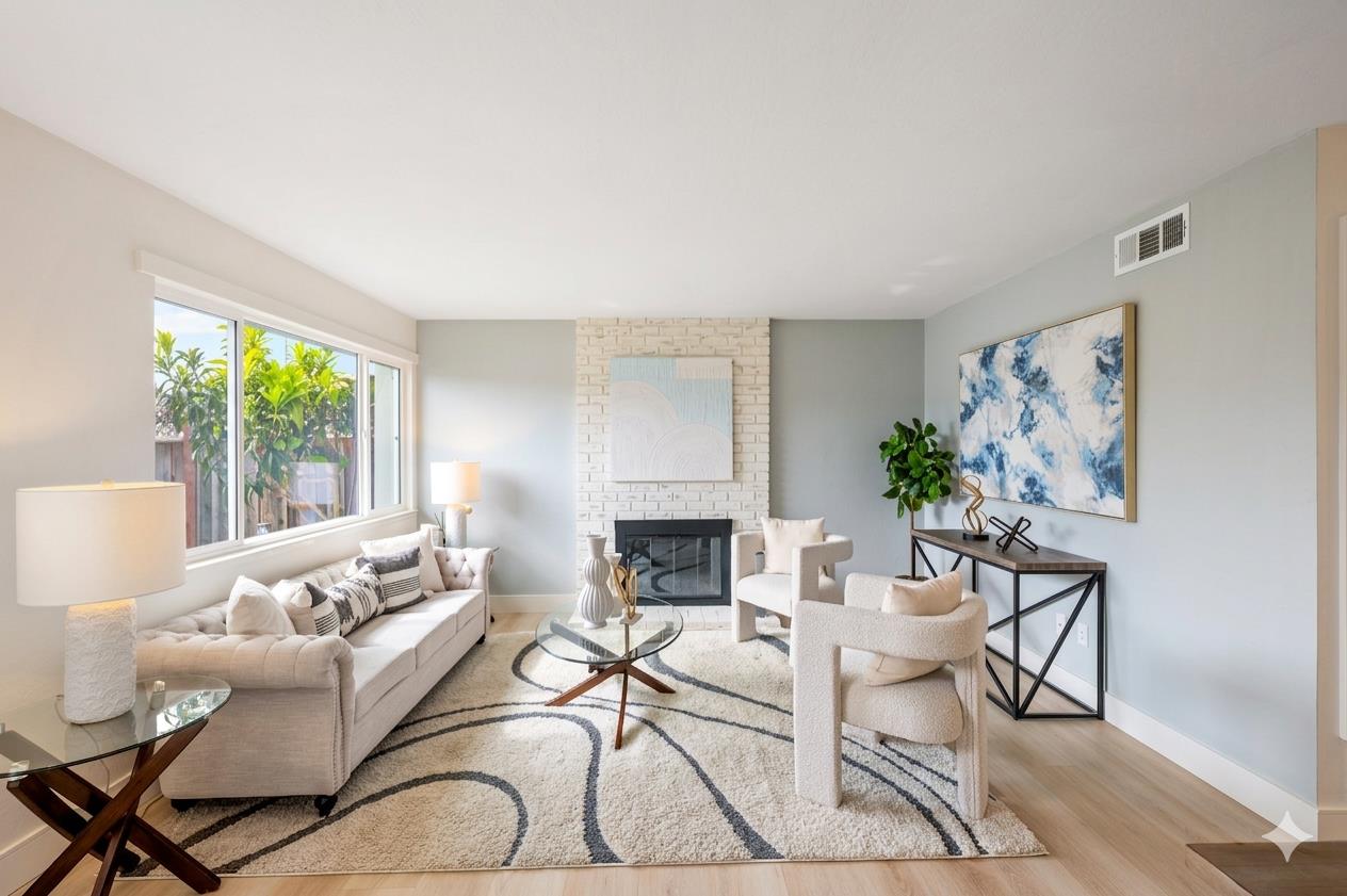 369 Timber Way Milpitas, CA 95035 - Photo 3 of 24 a living room with furniture a fireplace and a large window