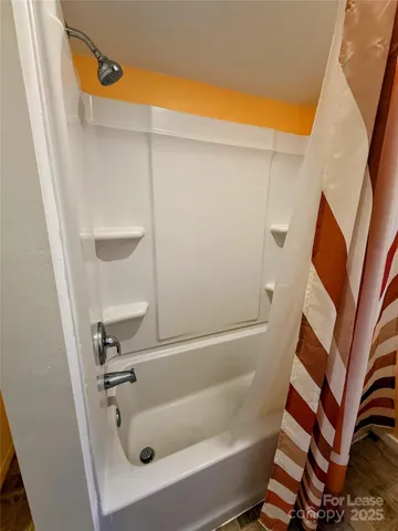 a bathroom with a tub and a shower