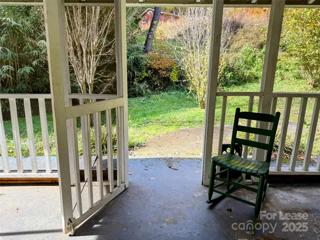 a view of a porch with chairs and backyard