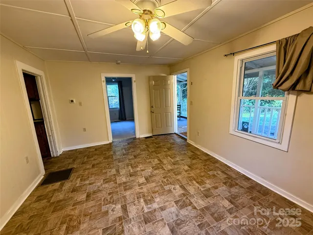 an empty room with windows and entrance