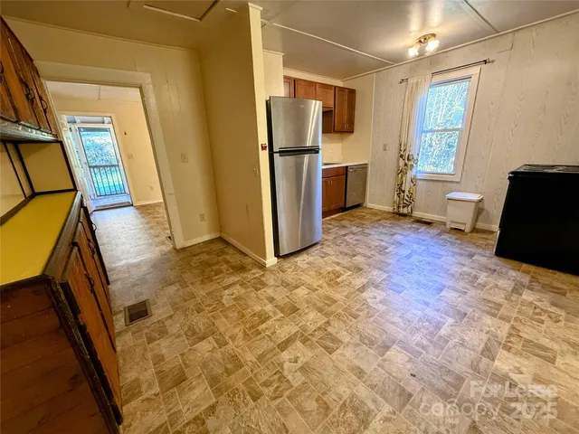 a view of a refrigerator in kitchen and livingroom