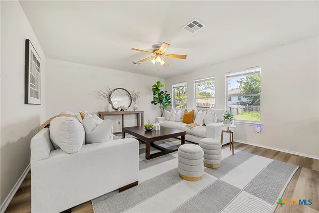 a living room with furniture a chandelier and a window