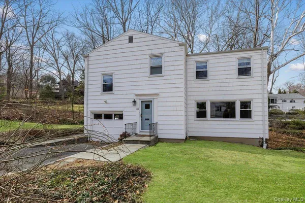 a view of house with backyard