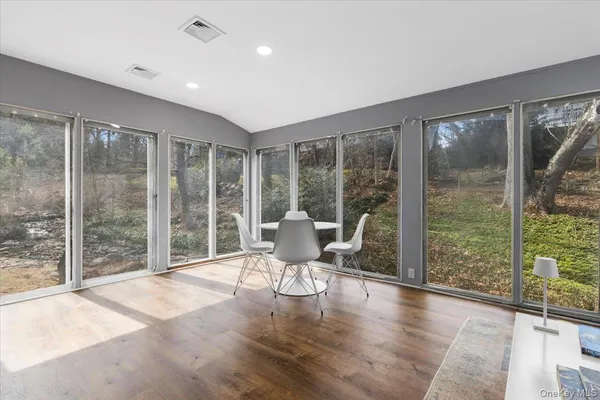 a living room with hardwood floor and balcony
