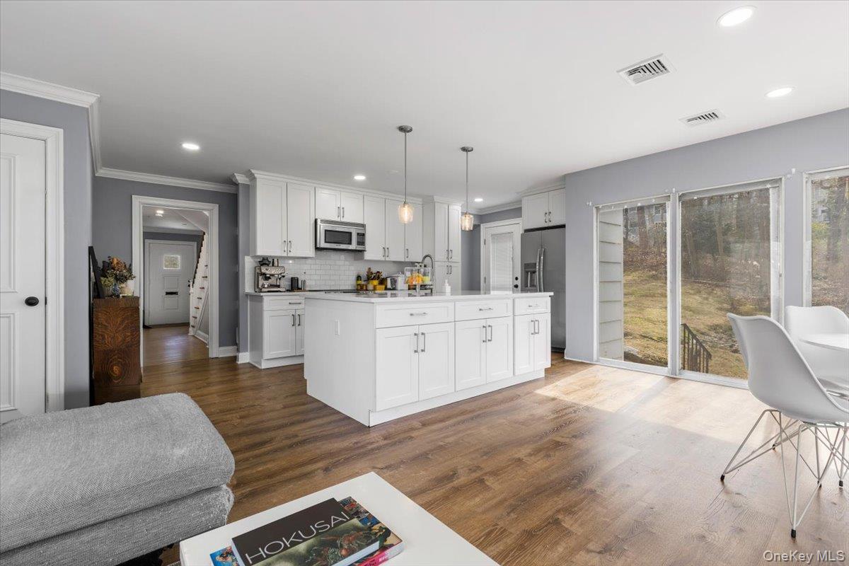 111 Spier Road Scarsdale, NY 10583 - Photo 16 of 37 a large white kitchen with cabinets and wooden floor
