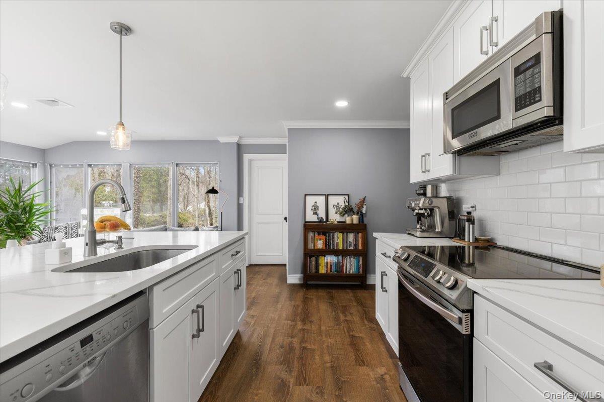 111 Spier Road Scarsdale, NY 10583 - Photo 17 of 37 a kitchen with stainless steel appliances granite countertop a sink a stove and a wooden floors