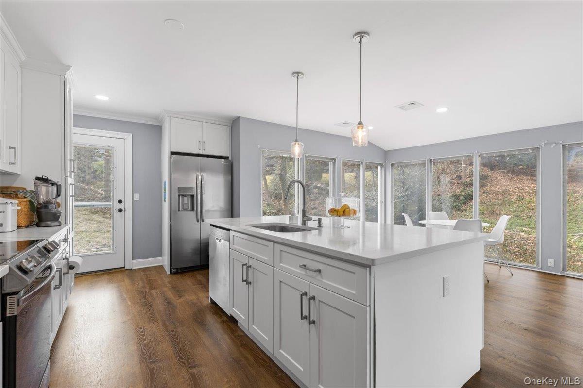 111 Spier Road Scarsdale, NY 10583 - Photo 18 of 37 a kitchen with counter top space sink and refrigerator