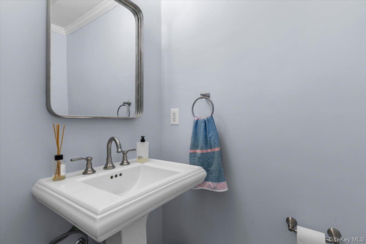 111 Spier Road Scarsdale, NY 10583 - Photo 19 of 37 a bathroom with a sink and a mirror